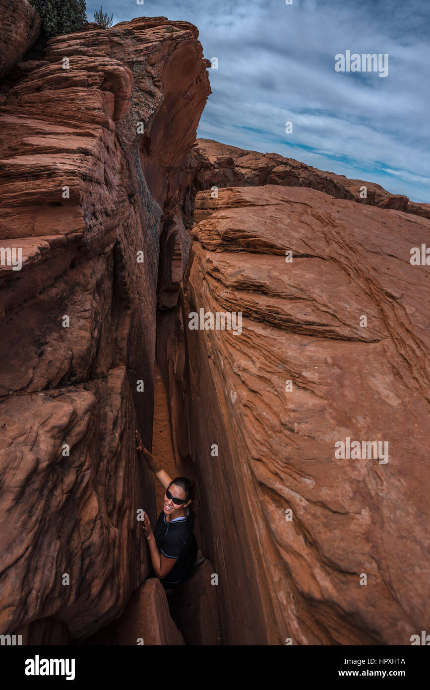 Smiling Hiker in Crack in the Wall Escalante Utah USA Stock Photo
