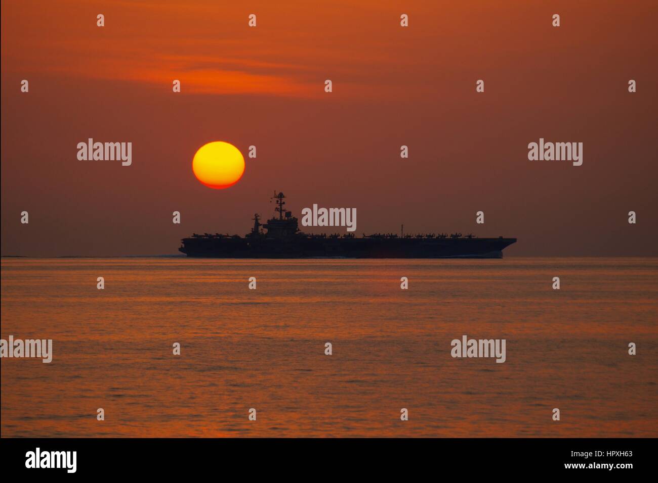 The Nimitz-class aircraft carrier USS John C Stennis operates in the Arabian Sea during sunset, Arabian Sea, January 5, 2012. Image courtesy of US Navy Yeoman 3rd Class James Stahl. Stock Photo