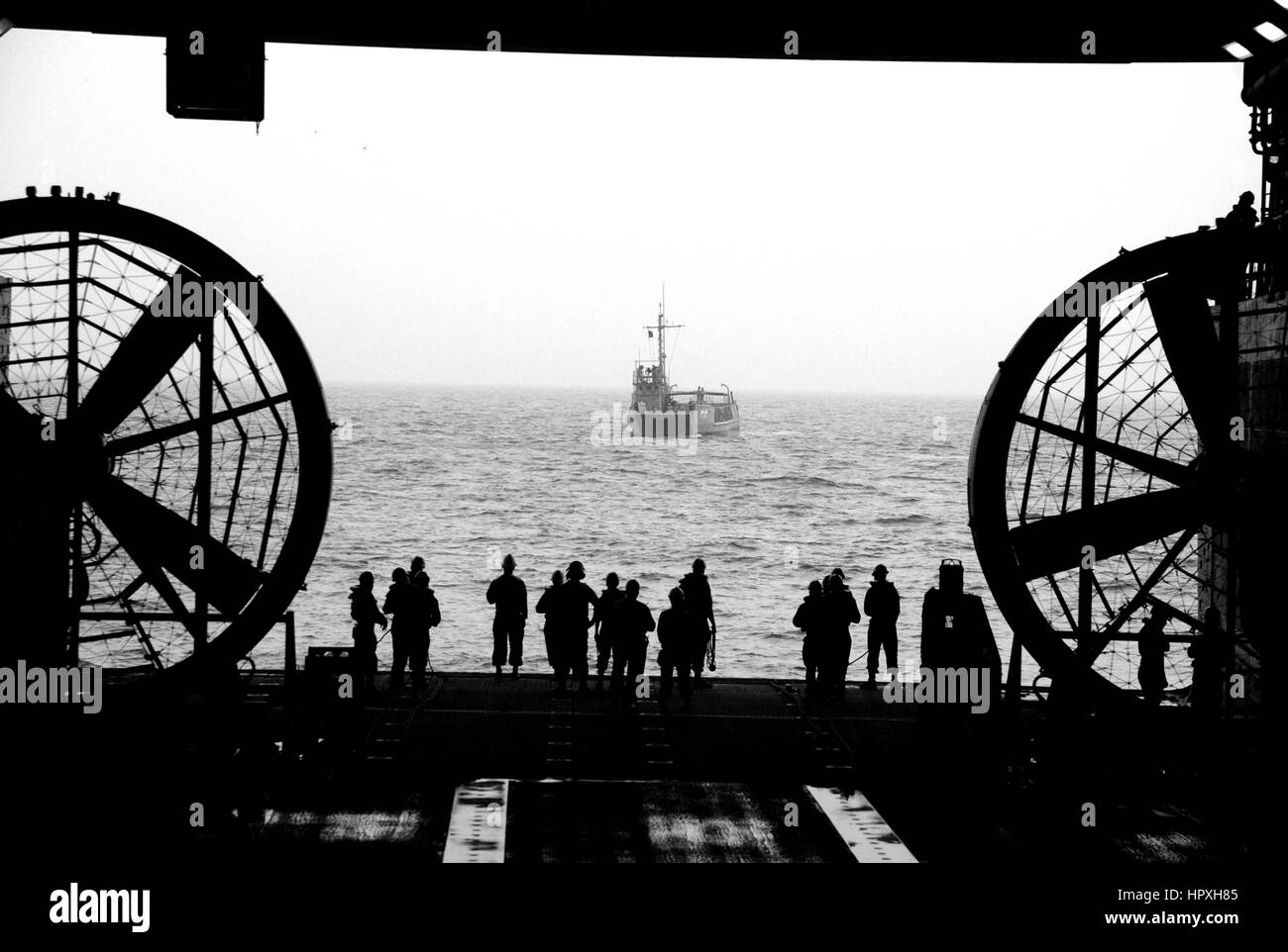 Sailors wait to perform a stern gate marriage with a utility landing craft in the well deck of the amphibious transport dock ship USS Green Bay, January 8, 2013. Image courtesy US Navy Mass Communication Specialist 1st Class Elizabeth Merriam. Stock Photo