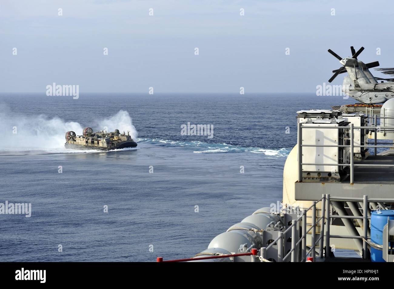 A landing craft air cushion approaches the stern of the amphibious assault ship USS Bonhomme Richard, East China Sea, February 2, 2013. Image courtesy US Navy. Stock Photo