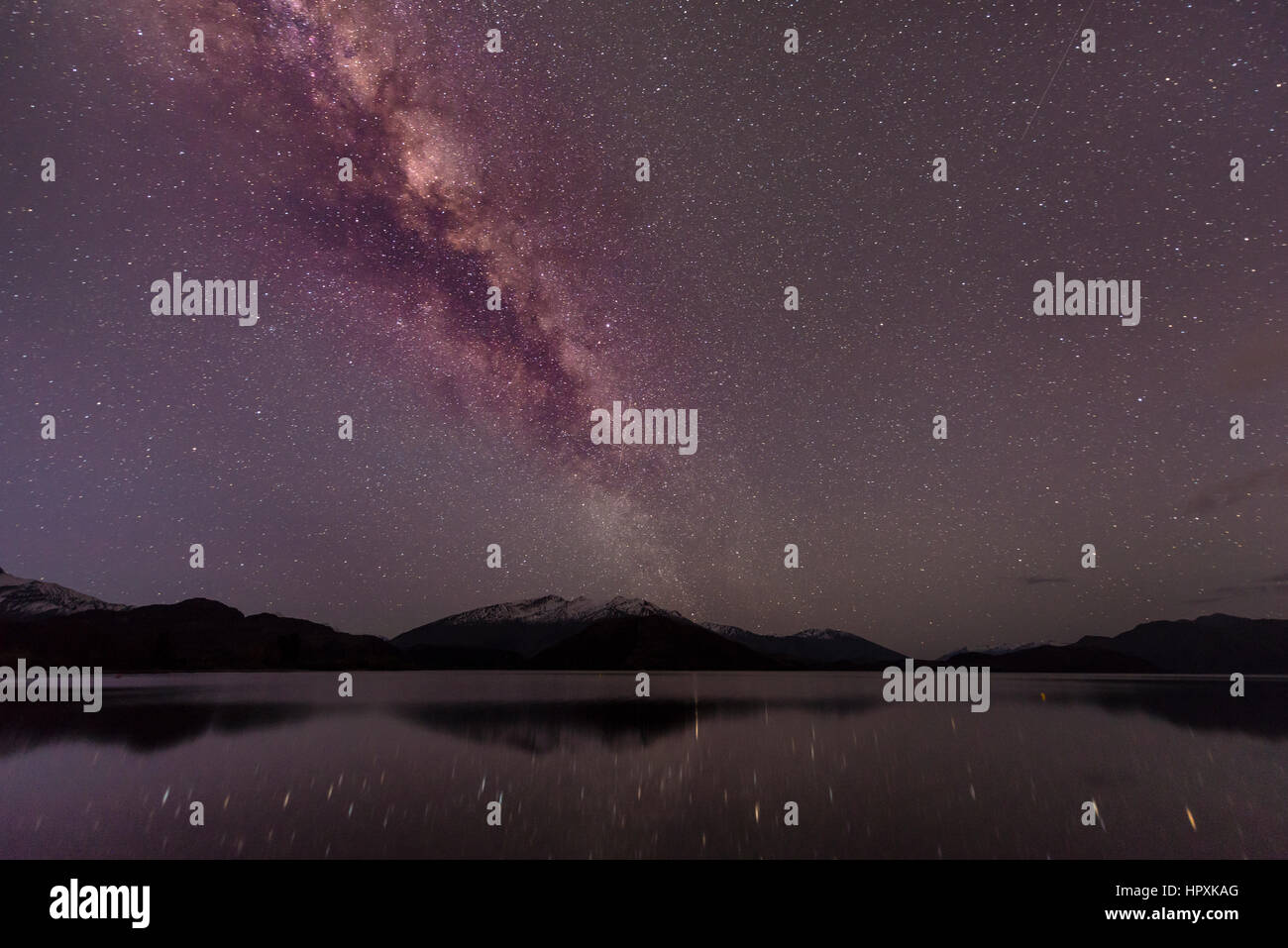 Night Scene, Wanaka lake with stars and Milky Way, stars mirroring in the water, Glendhu Bay, Otago, Southland, New Zealand Stock Photo