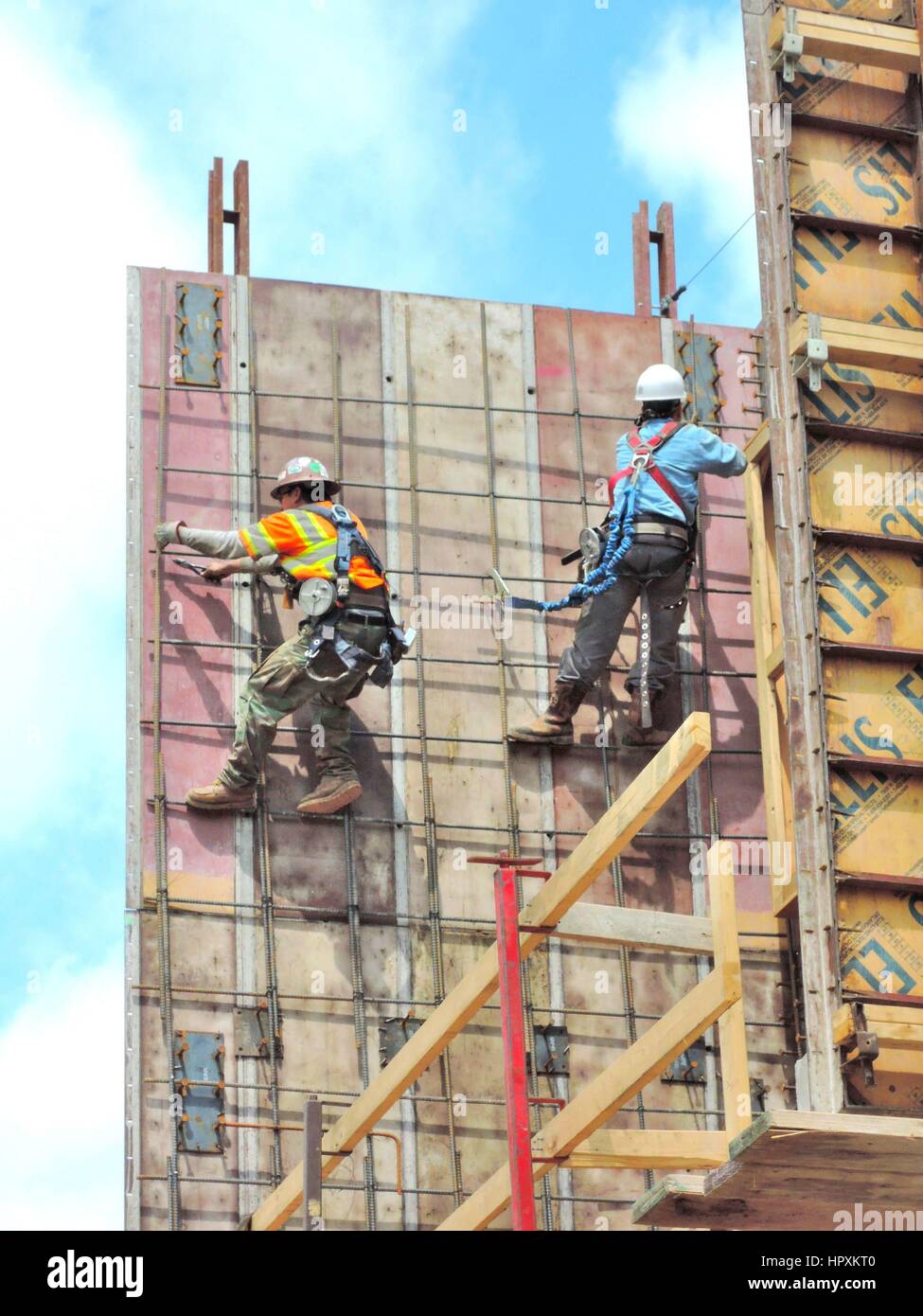 Construction Workers Working In Safety Harnesses Stock