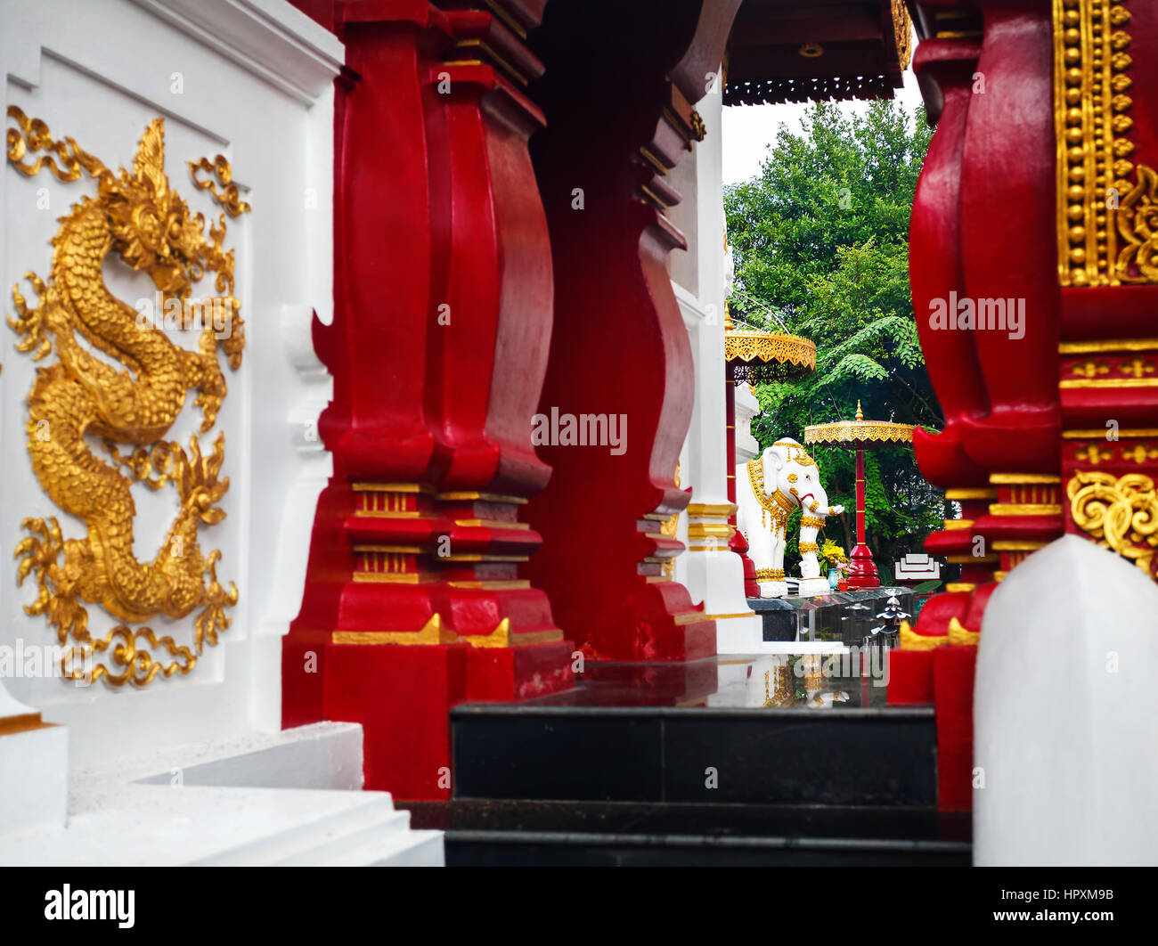Buddhist temple with white elephant red column with golden ornament in