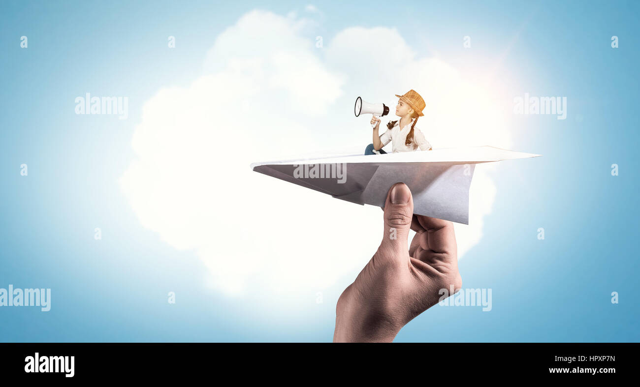 Cute kid girl flying in paper plane. Mixed media Stock Photo - Alamy