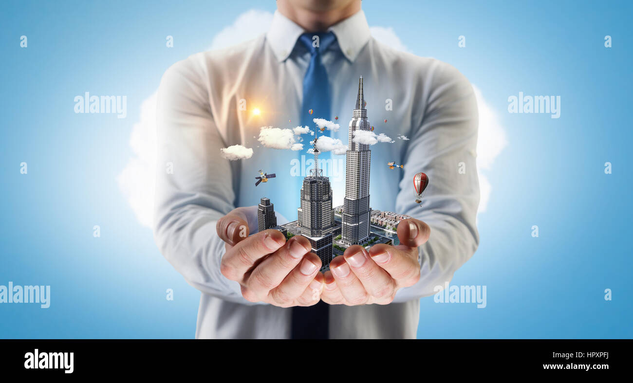 Close up of businessman hand holding construction model. Mixed media ...
