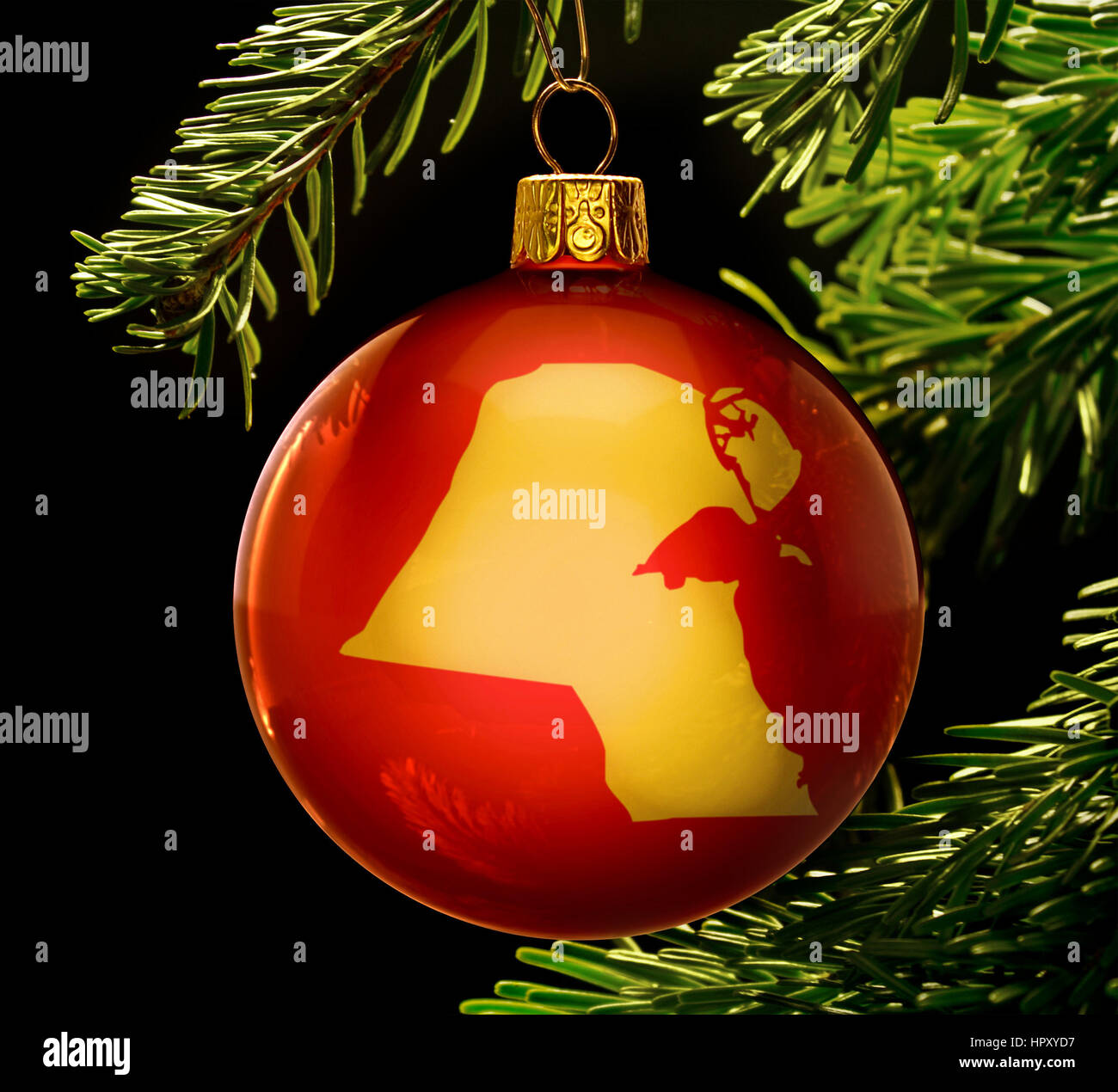 A red bauble with the golden shape of Kuwait hanging on a christmas