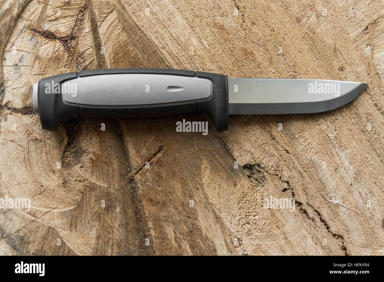 Skinning Knife. Knife for butchering venison. Knife on a wooden