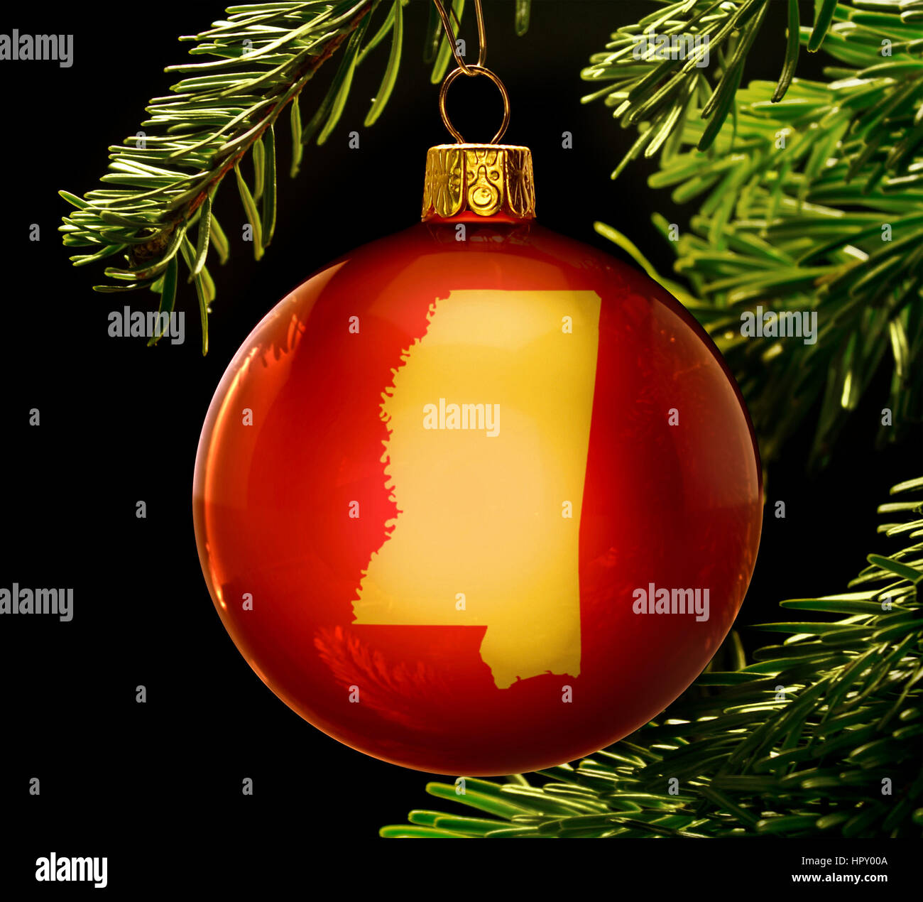 A red bauble with the golden shape of  Mississippi hanging on a christmas tree isolated on black.(series) Stock Photo