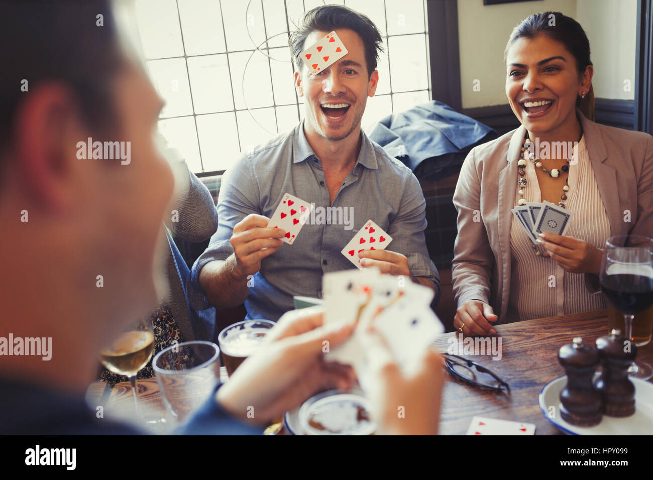 Friends playing Blind Man’s Bluff at bar Stock Photo