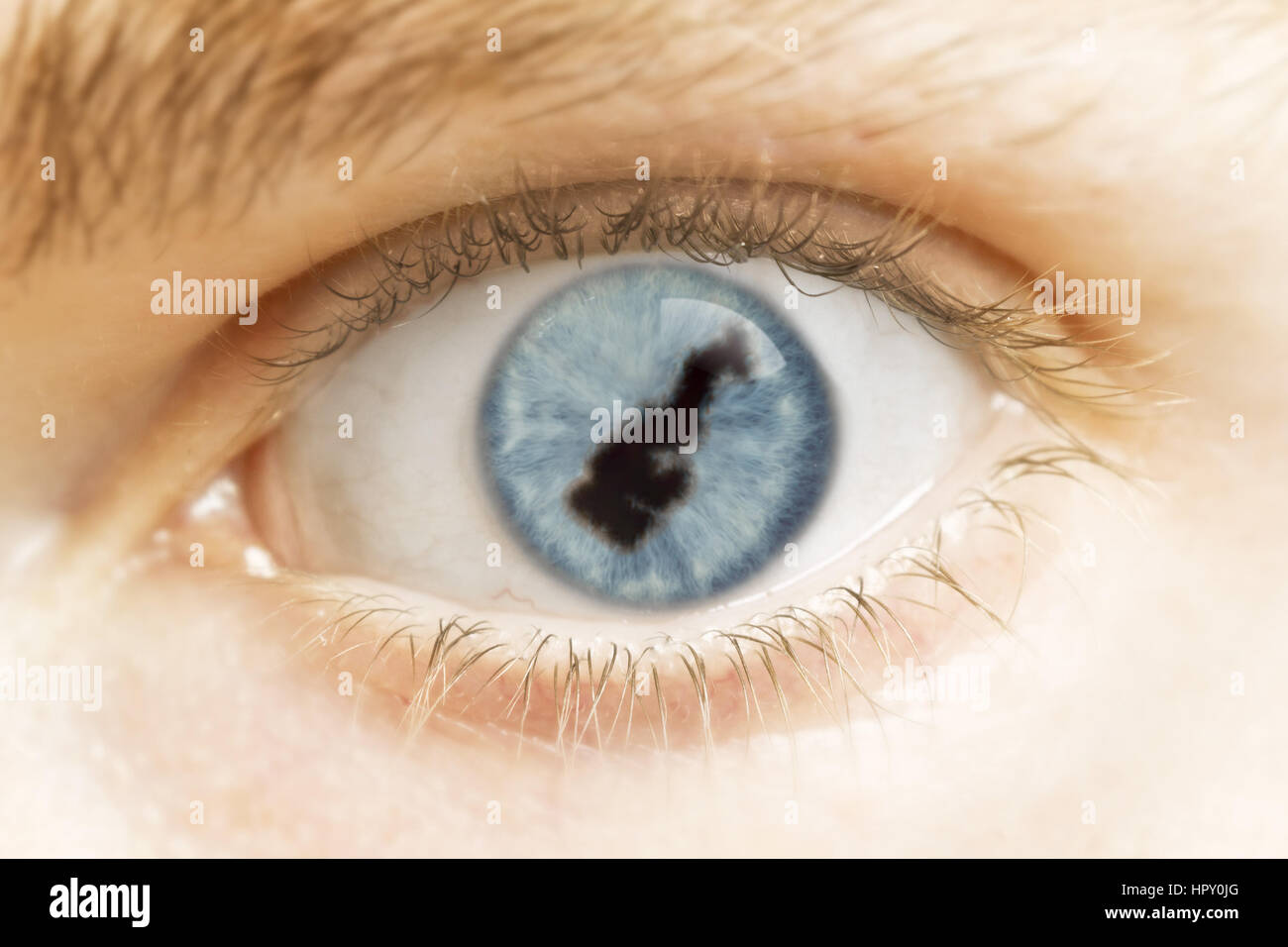 A close-up of an eye with the pupil in the shape of Monaco.(series) Stock Photo