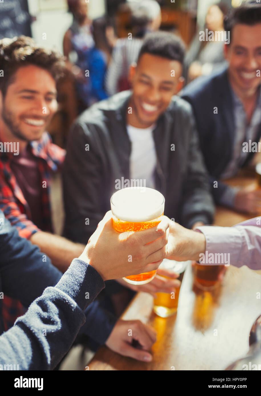 Waiter handing beer to man at bar Stock Photo