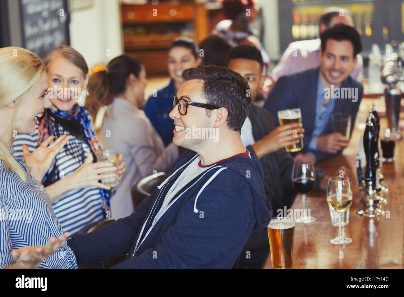 Enthusiastic man and woman greeting in bar Stock Photo