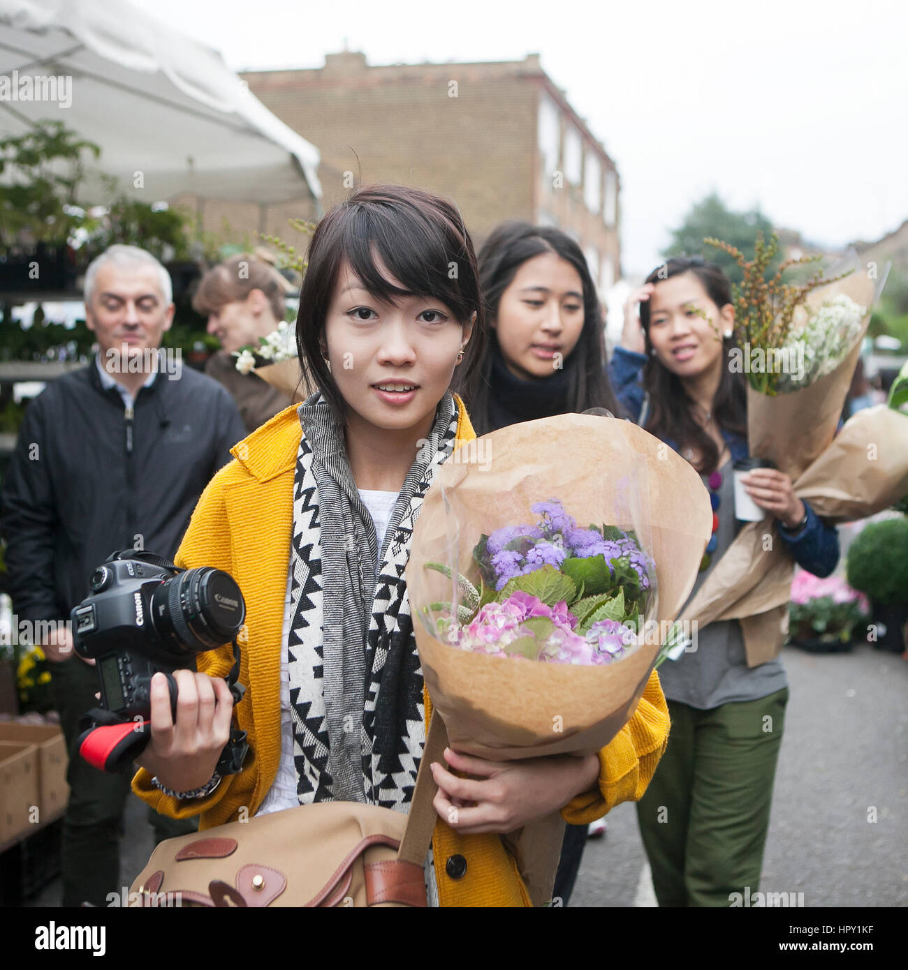 LONDON, ENGLAND - May 12, 2016 People gather at Columbia Road Flower Market in the East End of London. This market is as much social as it is about bu Stock Photo
