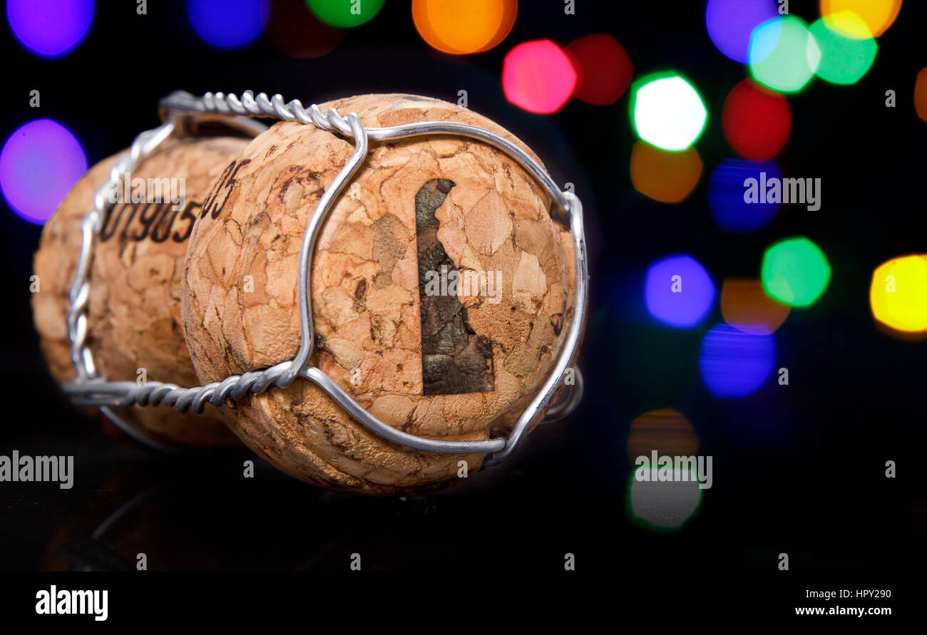 Champagne cork with the shape of Delaware burnt in and colorful blurry lights in the background.(series) Stock Photo