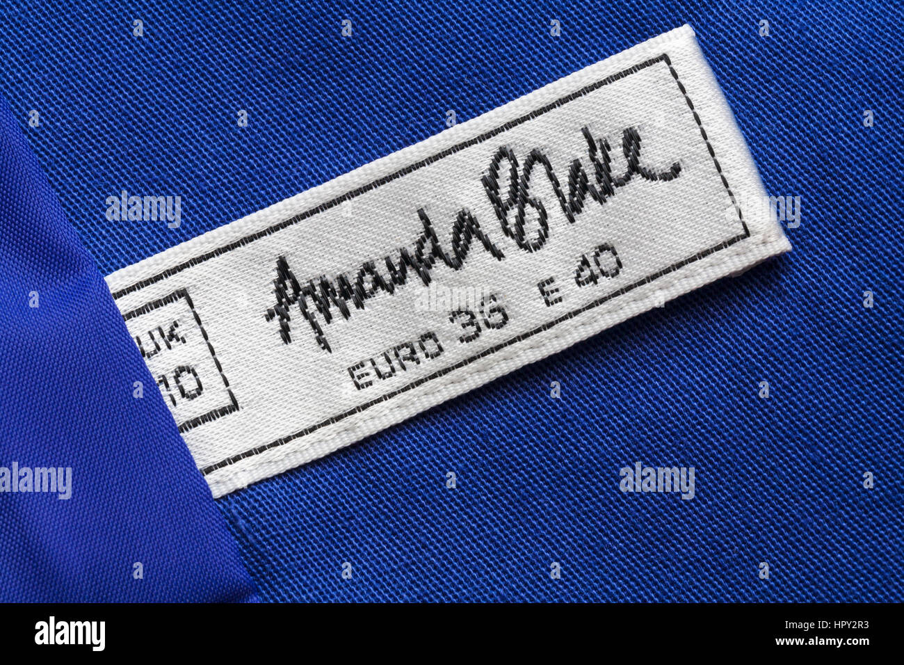 Amanda Blake label in woman's blue jacket Stock Photo