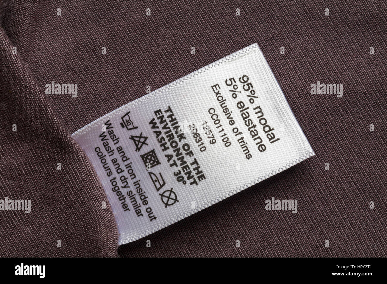 95% cotton 5% spandex label in woman's little black dress with beads made  in Hong Kong with wash care symbols and instructions Stock Photo - Alamy