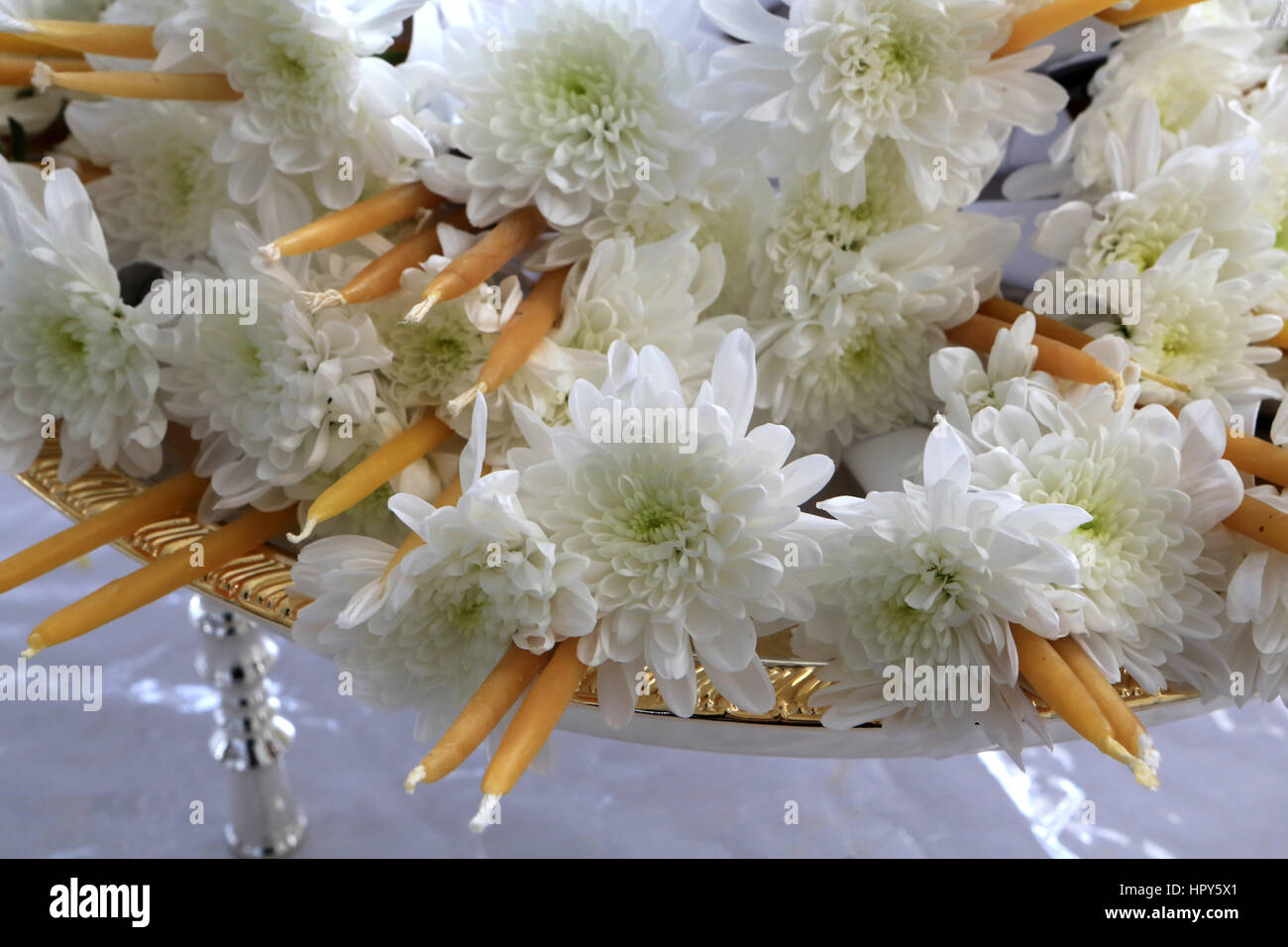 White flowers and candles. Buddhist offerings. Wat Velouvanaram Buddhist monastery. Bussy-Saint-Georges. Stock Photo