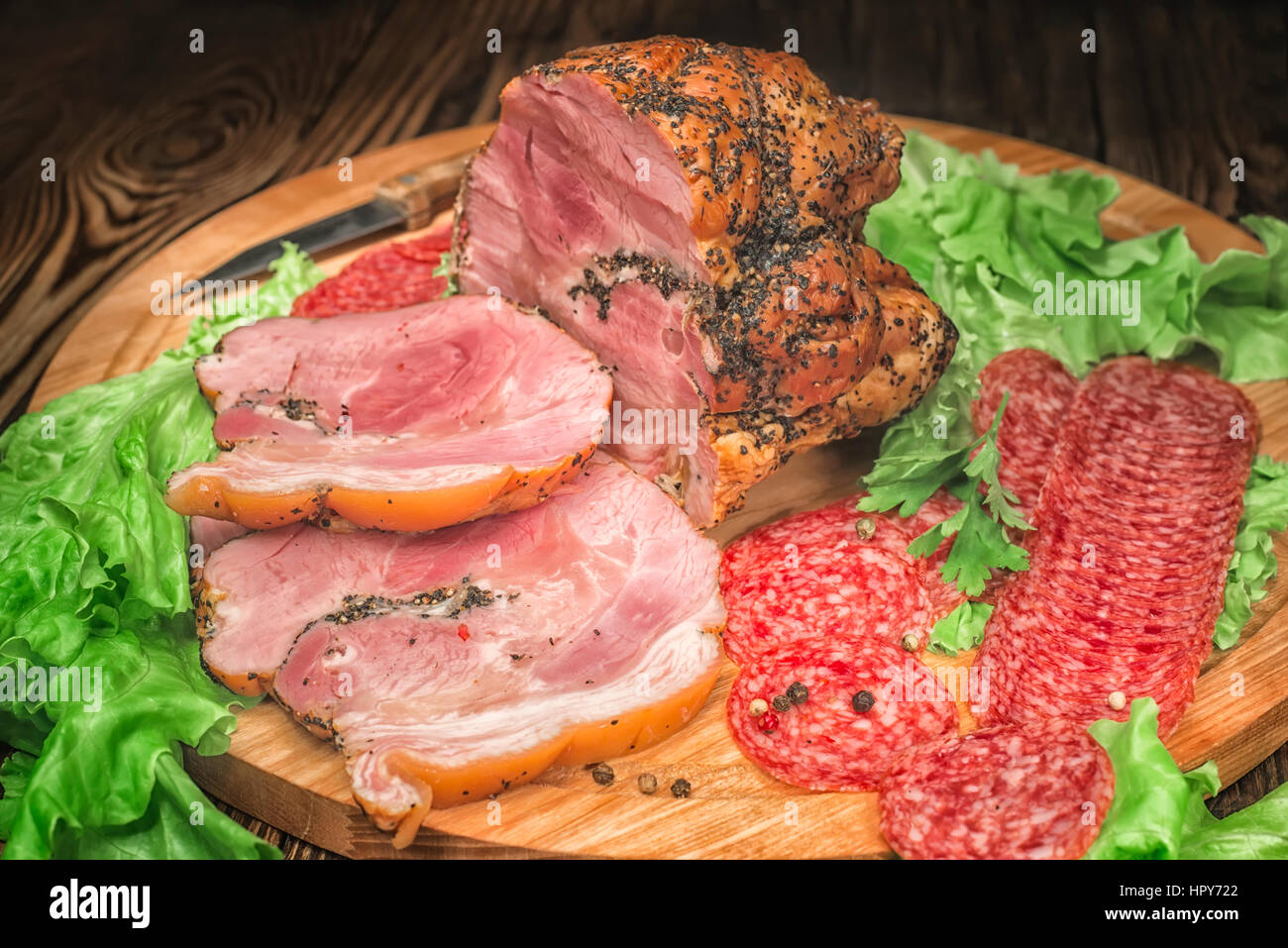 meat and salami with herbs on a cutting board Stock Photo - Alamy
