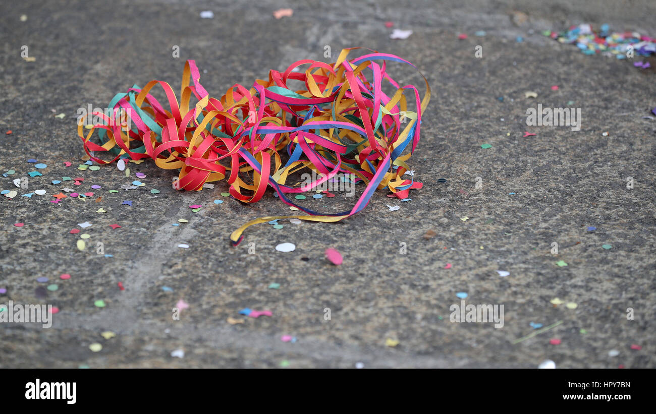 Colorful carnival leftovers on the ground background Stock Photo