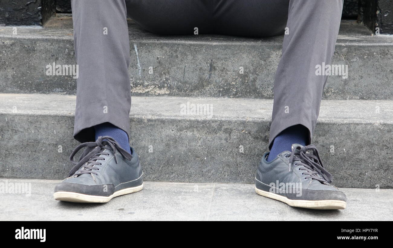 Shoes And Feet Of Man Sitting On Steps Stock Photo Alamy