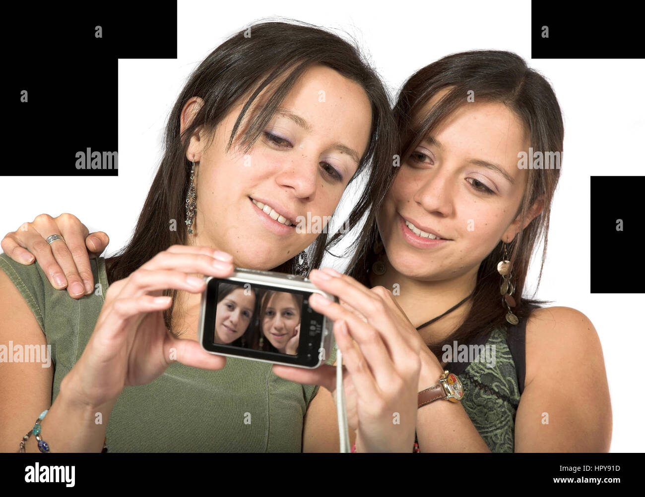 beautiful twins with digital camera over white Stock Photo