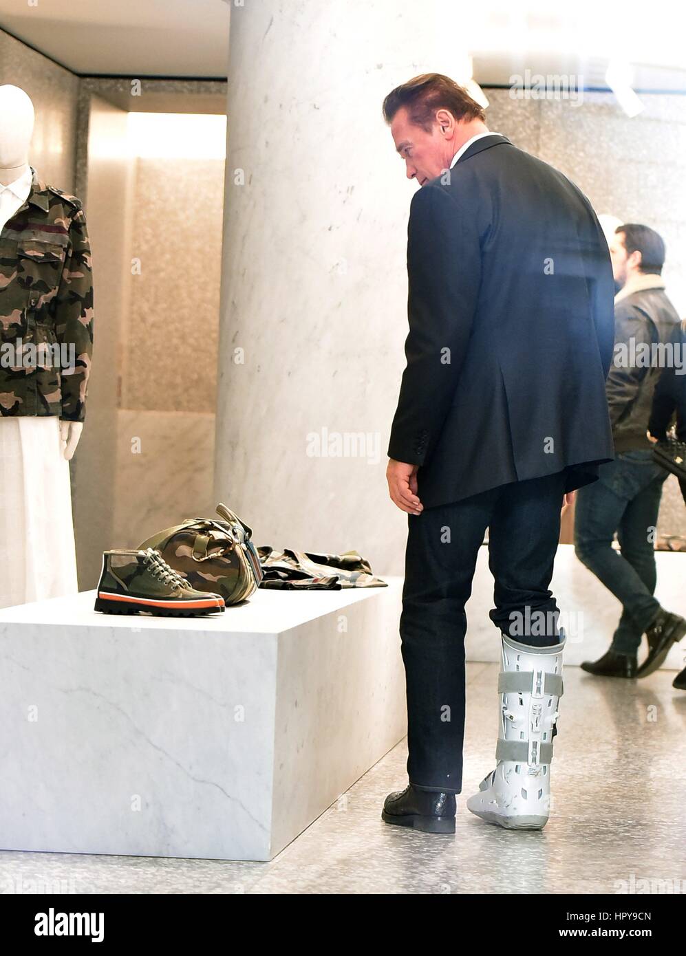Arnold Schwarzenegger and his girlfriend Heather Milligan go shopping at various boutiques in Rome, Italy. Arnold is seen wearing a Air Shield Walker on his right leg and happily walks around the city centre.  Featuring: Arnold Schwarzenegger Where: Rome, Italy When: 25 Jan 2017 Credit: IPA/WENN.com  **Only available for publication in UK, USA, Germany, Austria, Switzerland** Stock Photo