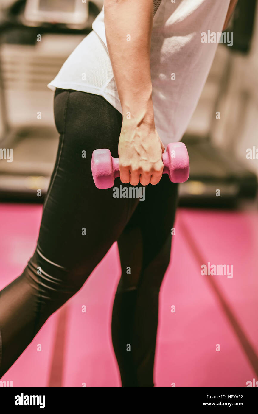 Young woman exercise with weights at the gym Stock Photo Alamy