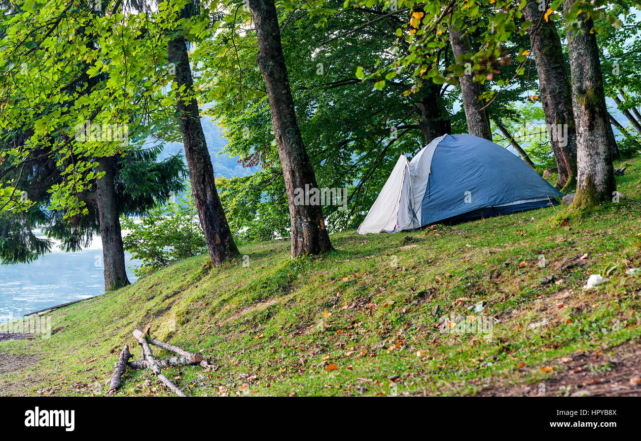 Camping tent on the bank of a lake panorama Stock Photo - Alamy