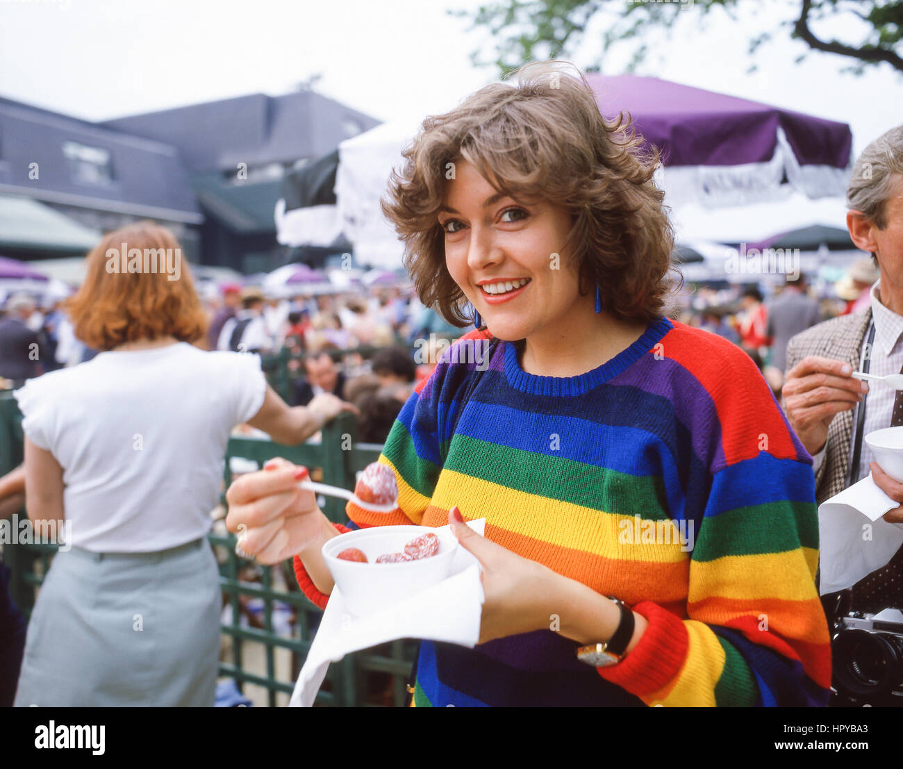 Young woman eating strawberries and cream at The Championships, Wimbledon, London Borough of Merton, Greater London, England, United Kingdom Stock Photo