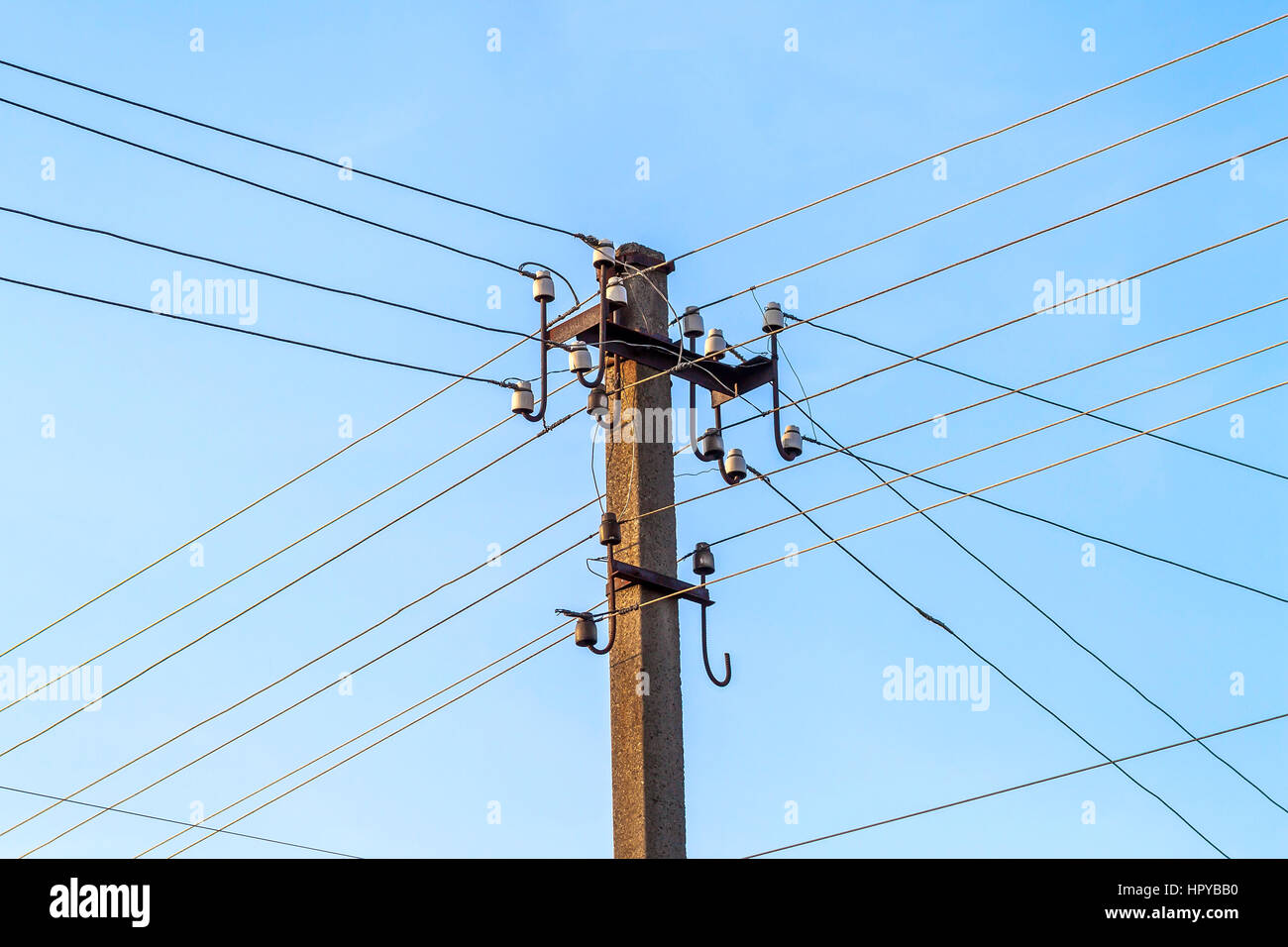 Electric pole power lines and wires with blue sky Stock Photo - Alamy