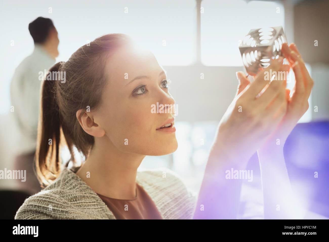 Focused design professional examining prototype part in office Stock Photo