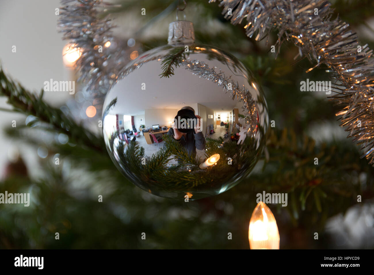 Reflection of the photographer in a shiny silver Christmas ball Stock Photo