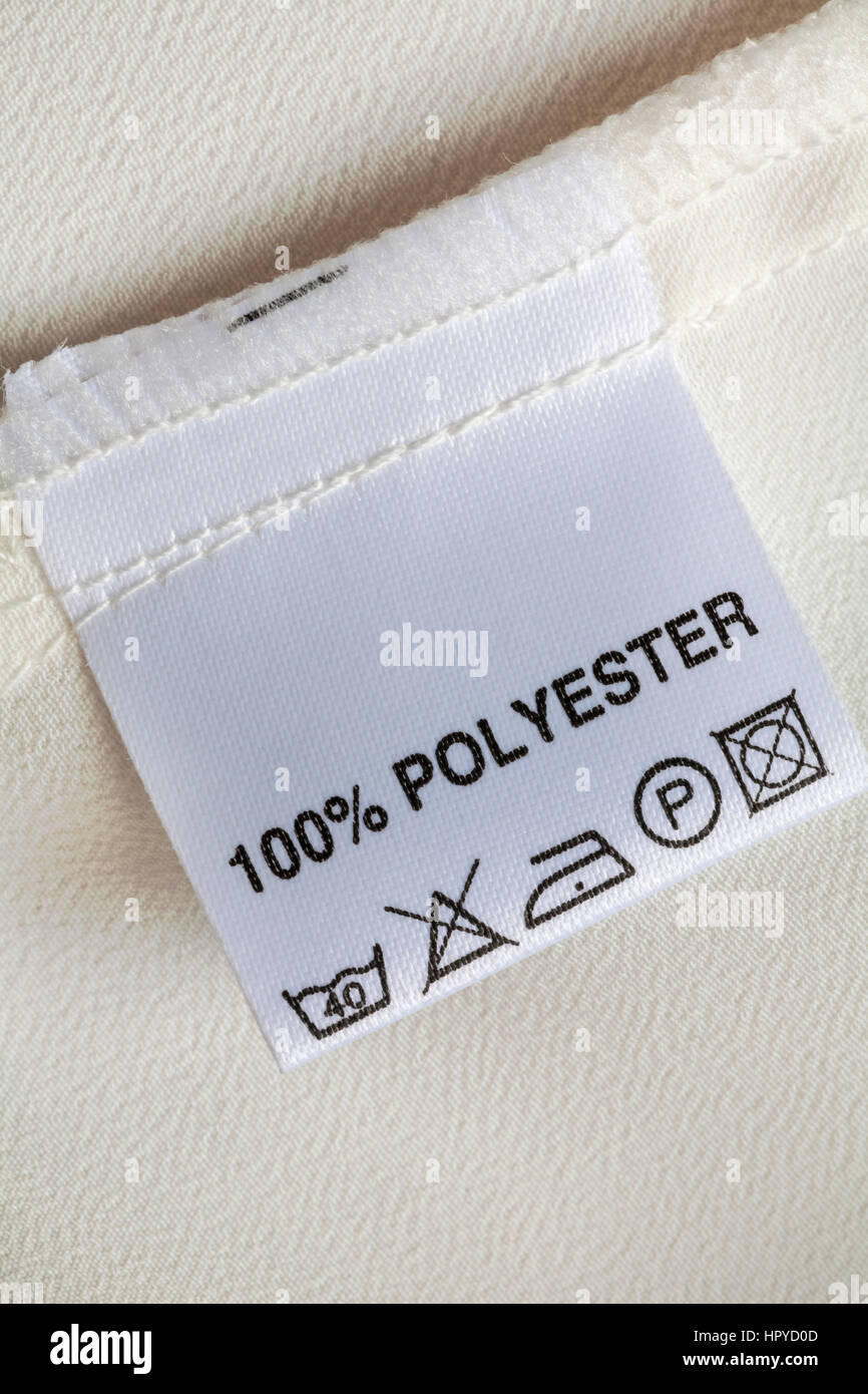 100% polyester label in woman's blouse with care washing instructions symbols Stock Photo