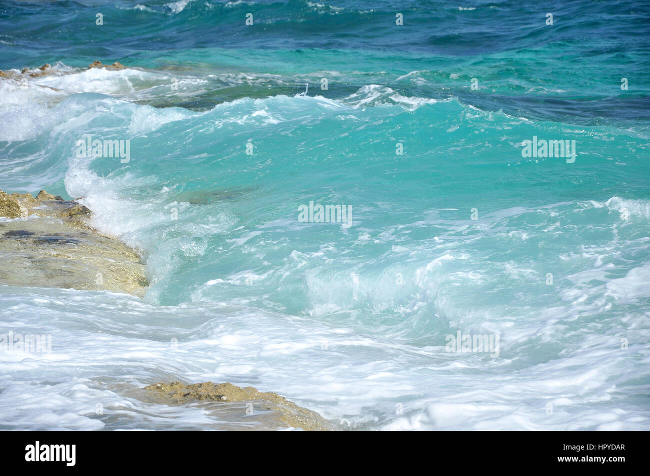 Ocean wave splashing the rocky coast Stock Photo - Alamy