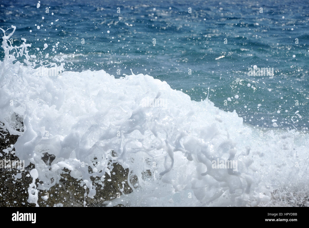 Ocean wave splashing the rocky coast Stock Photo - Alamy