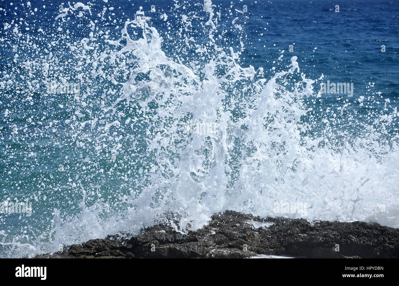 Ocean wave splashing the rocky coast Stock Photo - Alamy