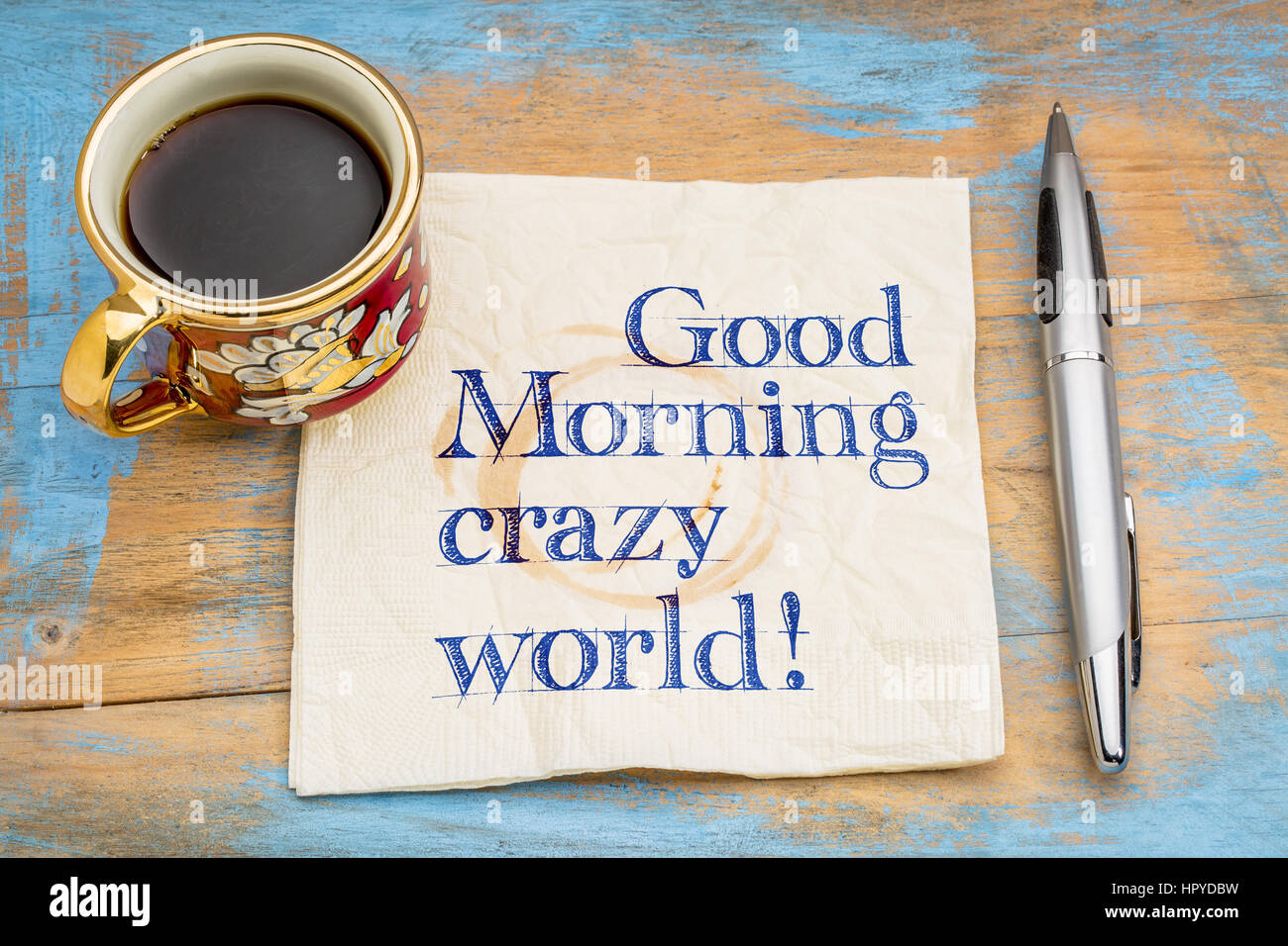 Good Morning crazy world - handwriting on a napkin with a cup of espresso coffee Stock Photo
