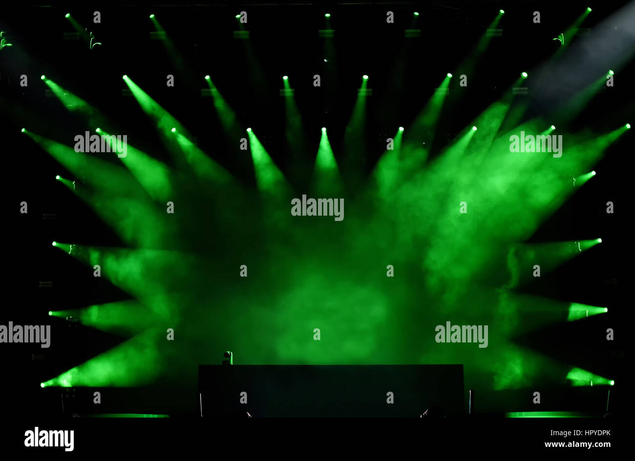 Green stage lights projecting on empty stage Stock Photo