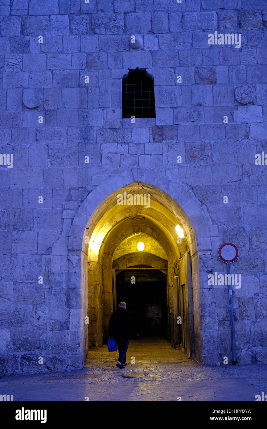 A pedestrian entering Herod's gate also Bab el Zahra or Shaar ha
