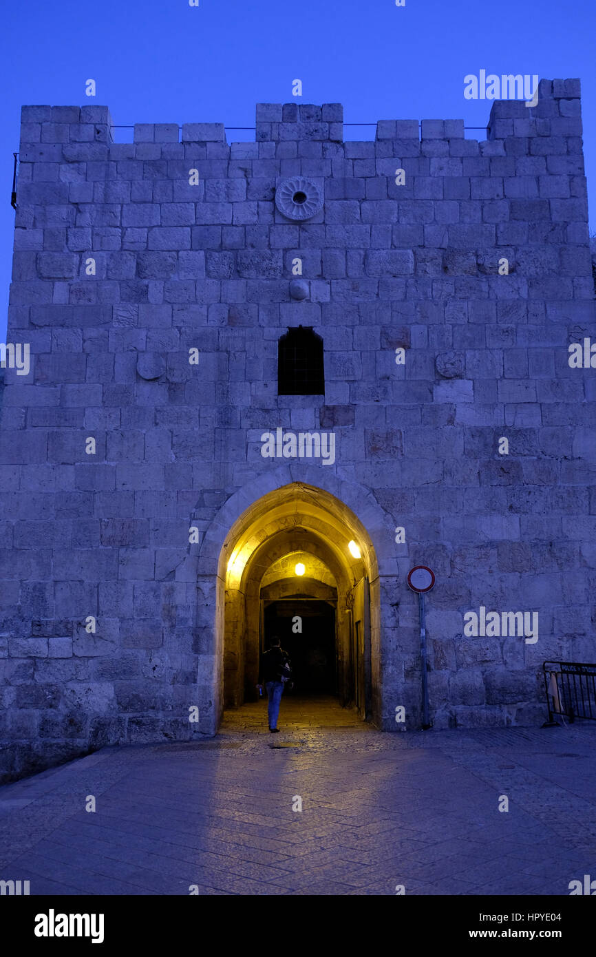 A pedestrian entering Herod's gate also Bab el Zahra or Shaar ha