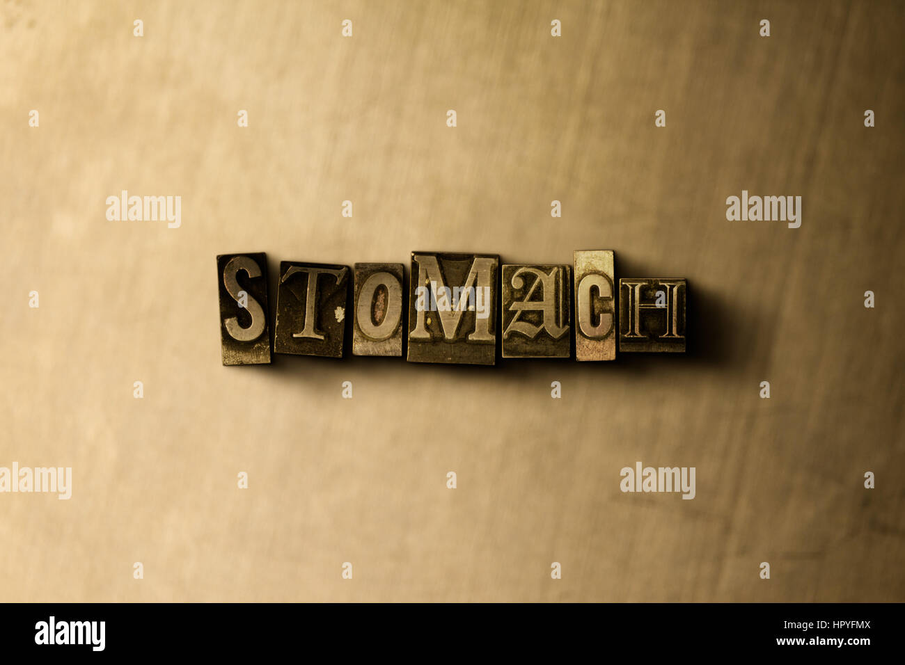 STOMACH - close-up of grungy vintage typeset word on metal backdrop ...