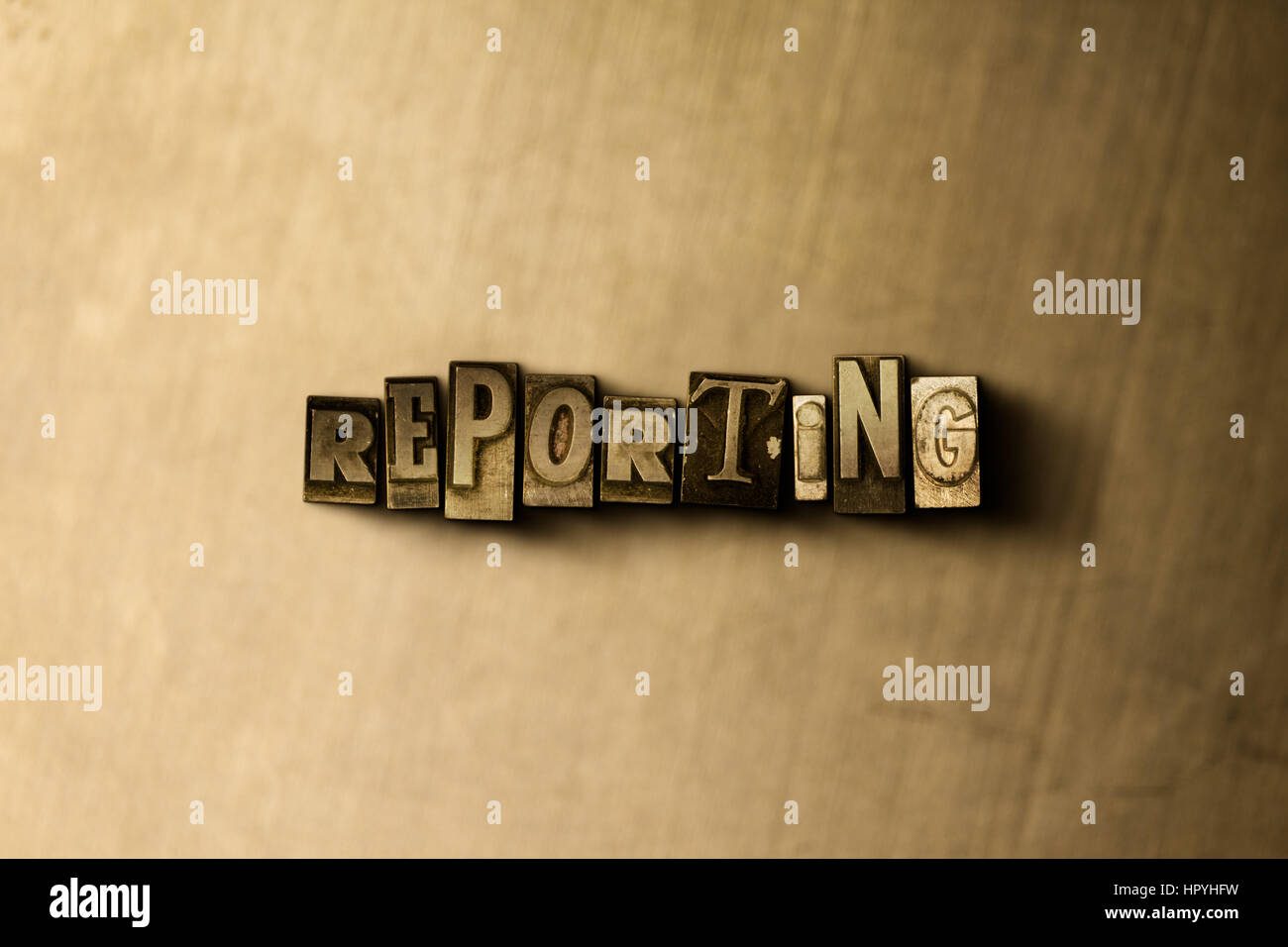 Reporting Close Up Of Grungy Vintage Typeset Word On Metal Stock