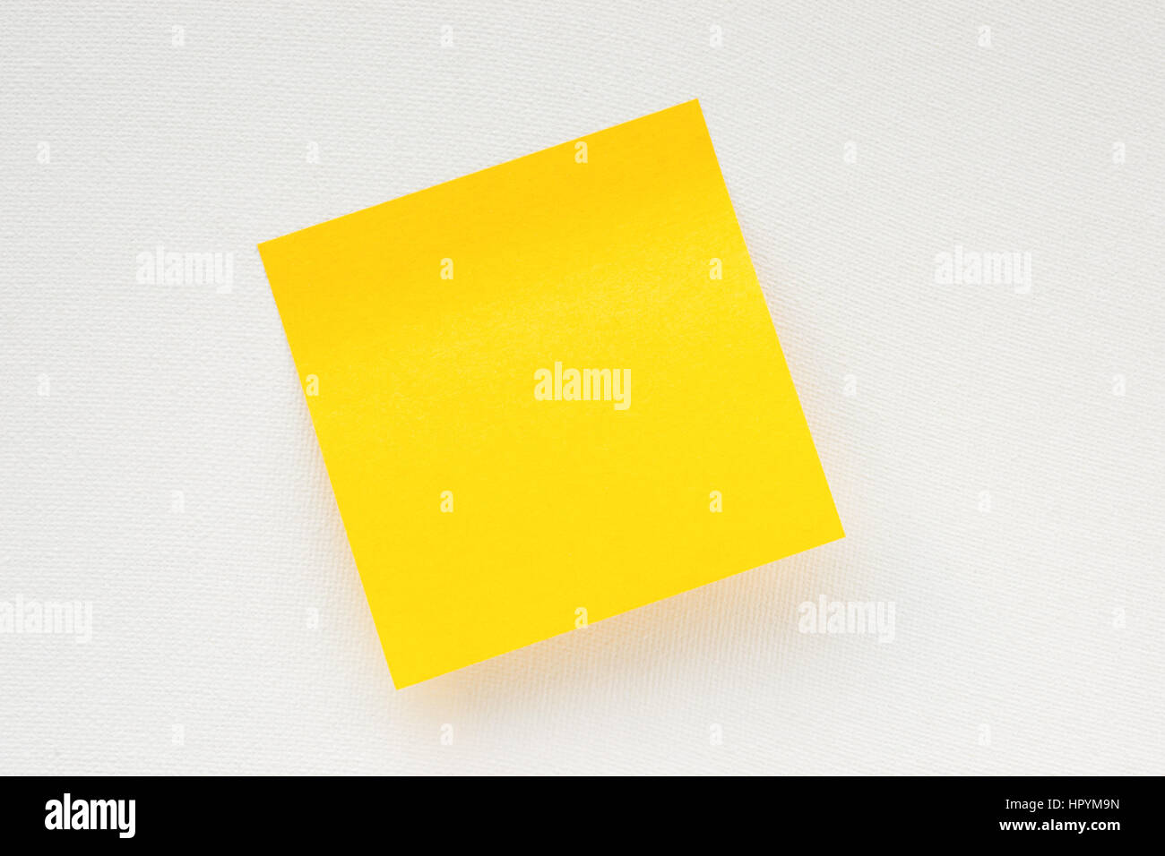 Yellow sticky note on white canvas background. Memo template Stock