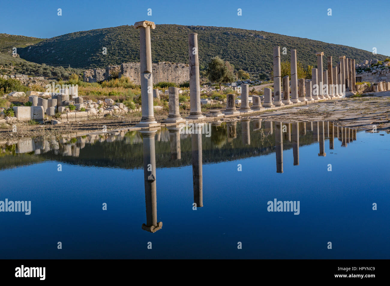 reflections of the columns on the pond surface pillar street of ancient patara Stock Photo