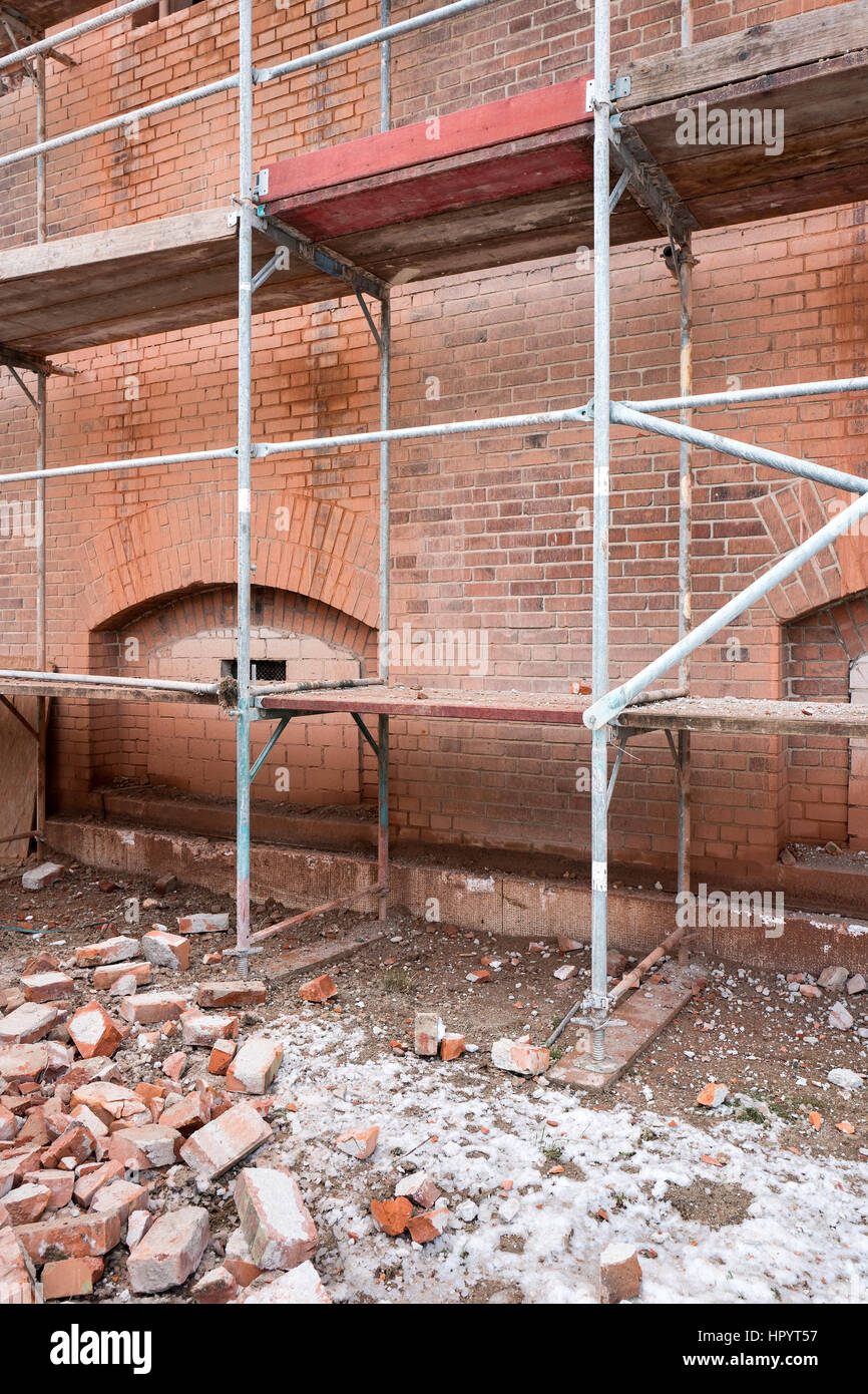 scaffolding at historic brick wall building currently under