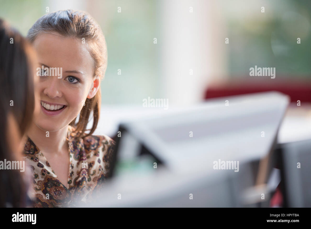 Smiling businesswomen at computer in office Stock Photo - Alamy