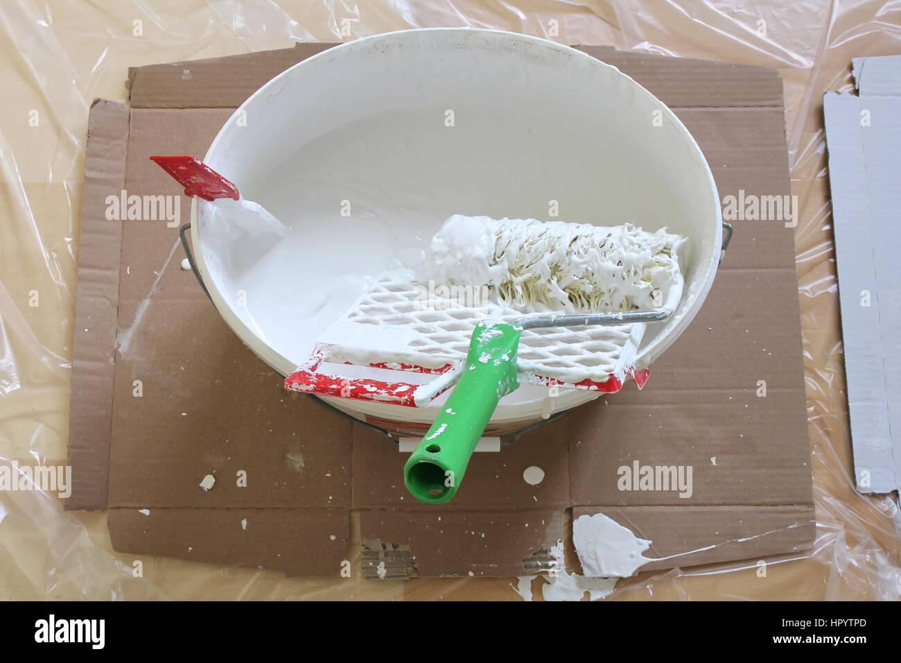 emulsion paint on covered parquet floor Stock Photo