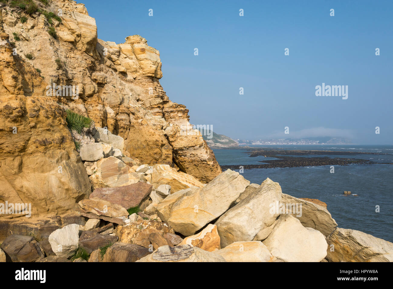 View from Knipe point (Osgodby point) near Scarborough on the coast of North Yorkshire, England. A beautiful sunny day on the rocky headland. Stock Photo