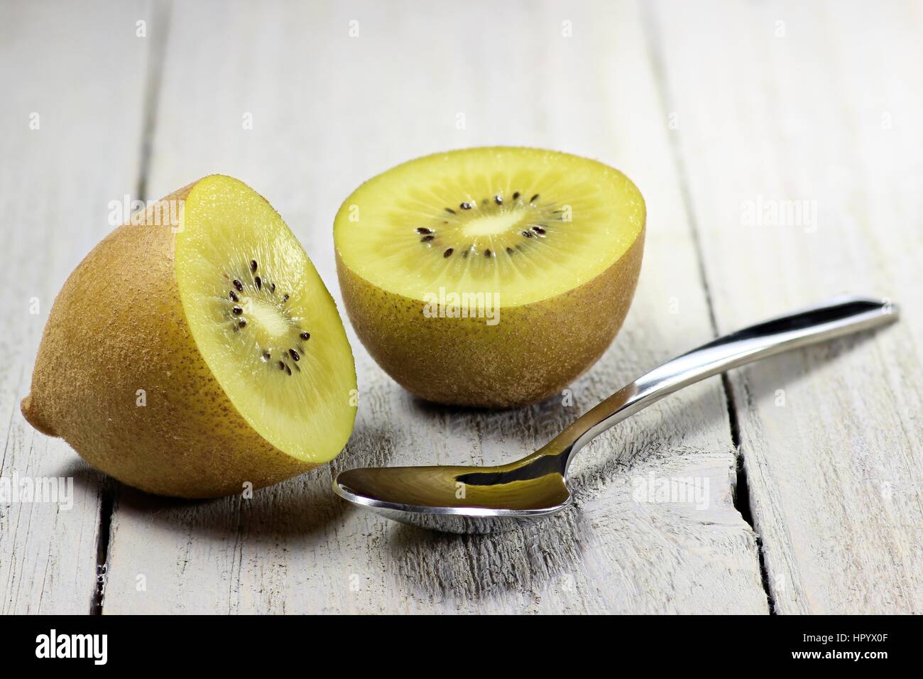 golden kiwifruit ion wooden background Stock Photo