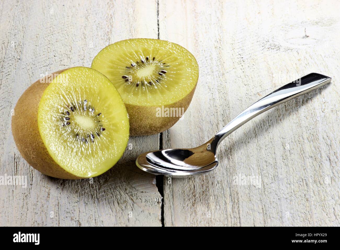 golden kiwifruit ion wooden background Stock Photo